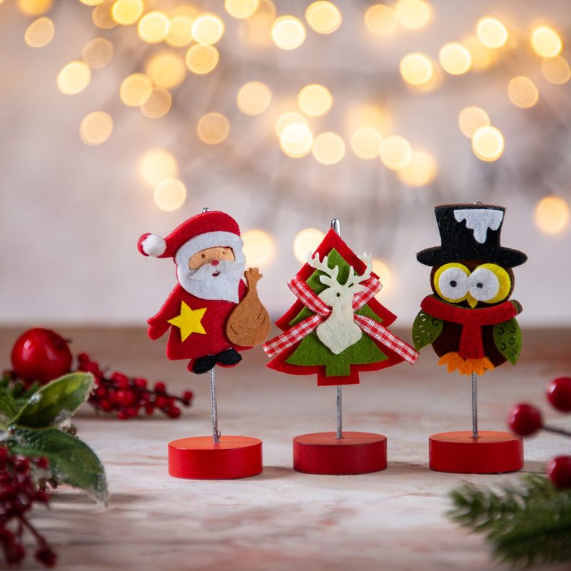 little-santa-decoration-with-owl-figure-xmas-tree-christmas-texture-blurred-background-min